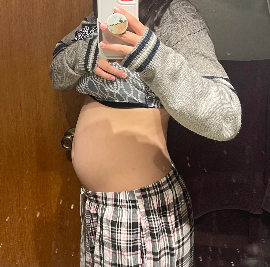 Woman with bloated stomach after eating
